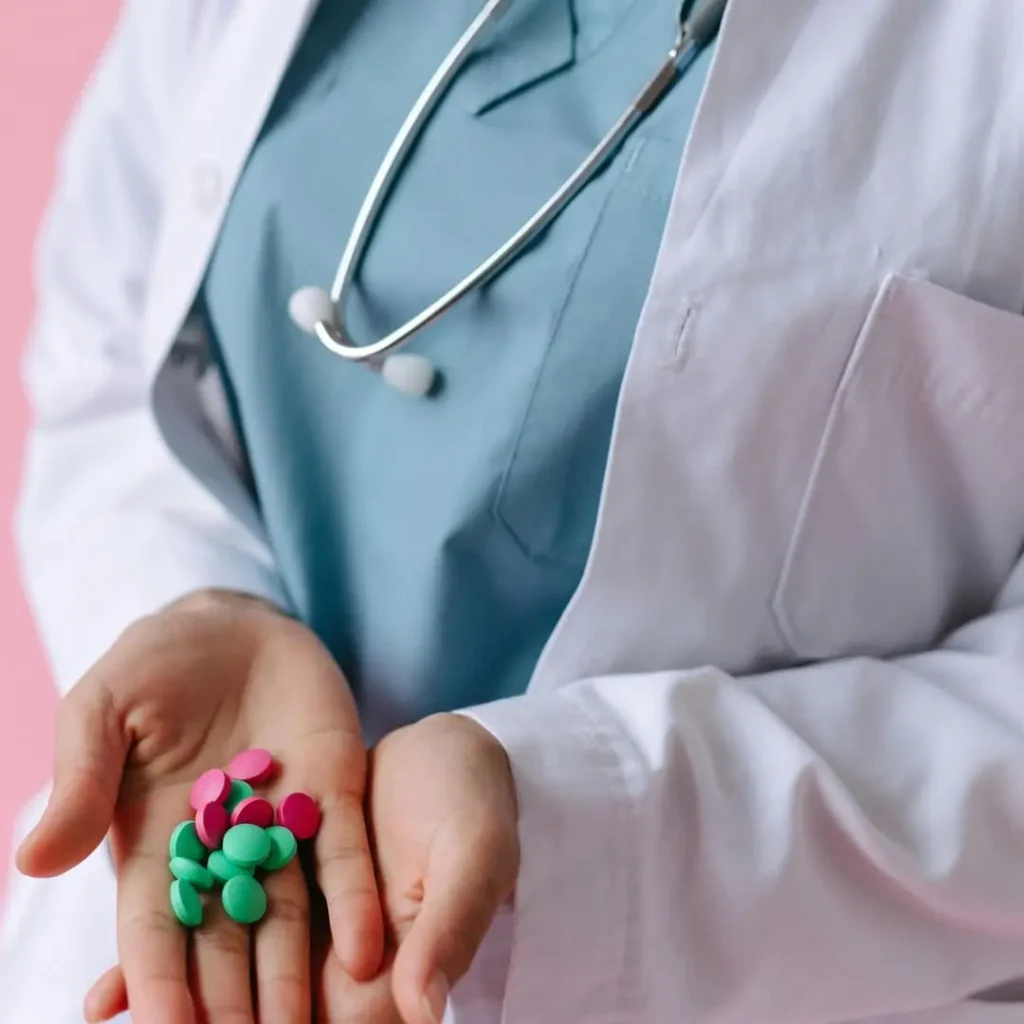 A doctor wearing a white coat and a stethoscope holding a handful of green and pink pills, with the title 'How To Ask Your Doctor for Weight Loss Pills | 3 Step Guide' included.