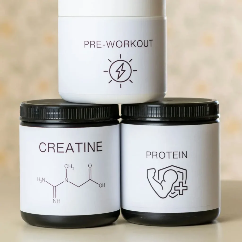 A set of three supplement containers labeled 'Pre-Workout,' 'Creatine,' and 'Protein,' neatly stacked on a table, with the title 'Is Creatine Good for Weight Loss? A Nutritionist’s Perspective' included.