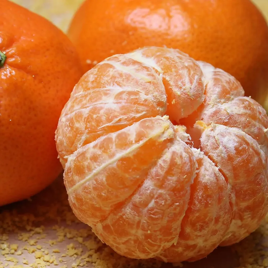 A peeled orange placed next to whole oranges, with the title "Are Oranges Good for Weight Loss?" written clearly on the image.